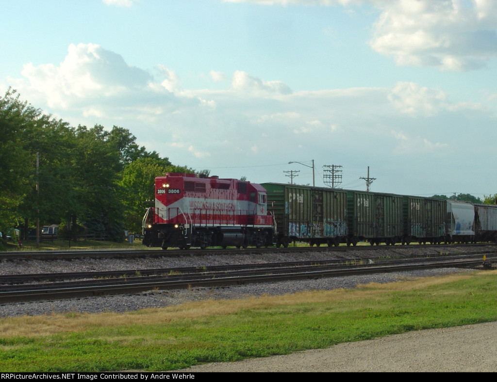 WSOR 3806 has shoved the cut of cars back into the yard